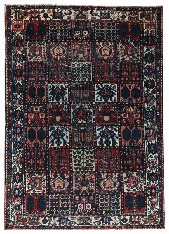 Full overhead view of the navy and red vintage Anatolian wool area rug with a geometric grid pattern.