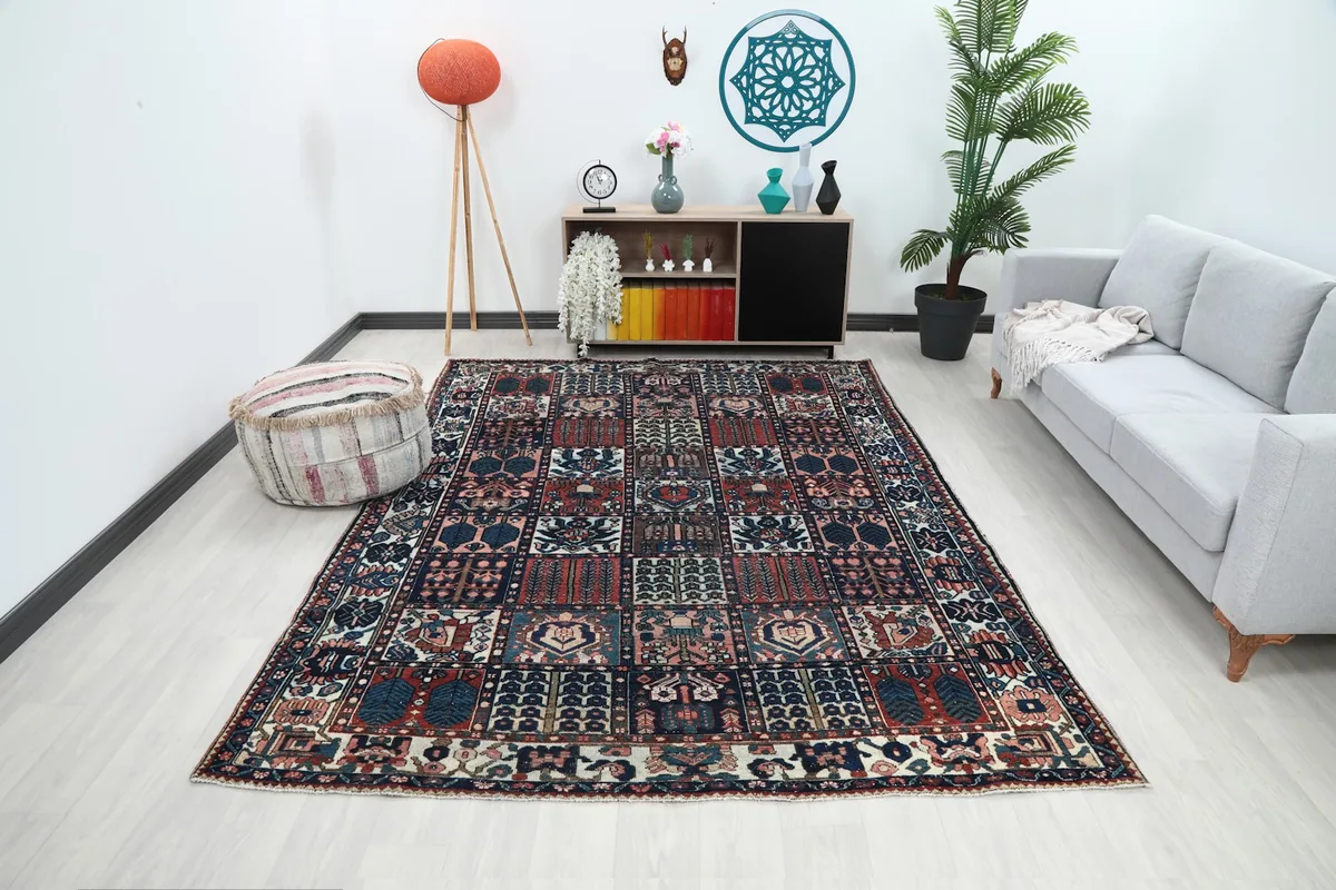 Vintage Anatolian rug displayed in a bright living room setting with a light gray sofa and modern decor.