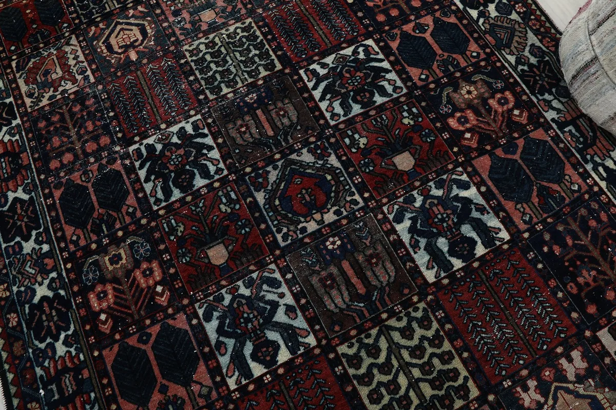 Detailed view of the rug's pile and weave, showcasing the varied patterns within the grid design.