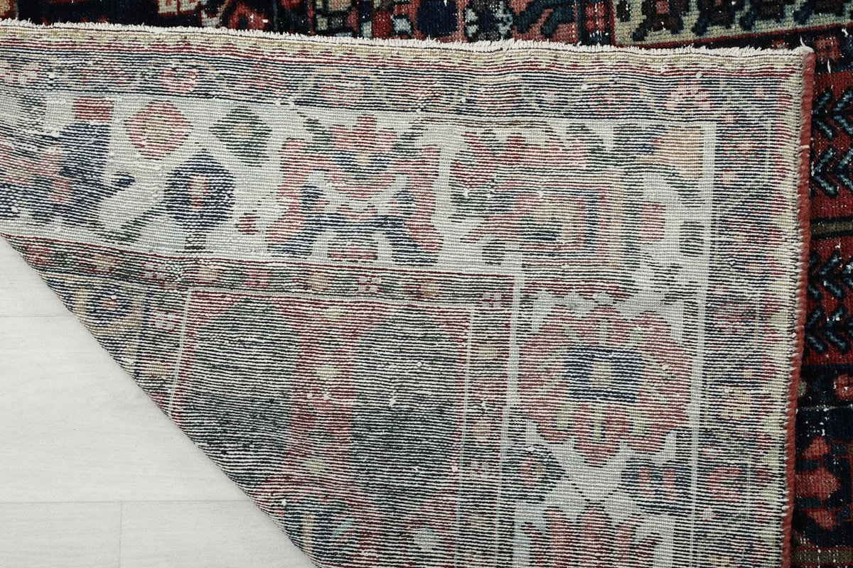 Detailed view of the rug's cotton foundation from the back, showing the consistent knotting and weave.