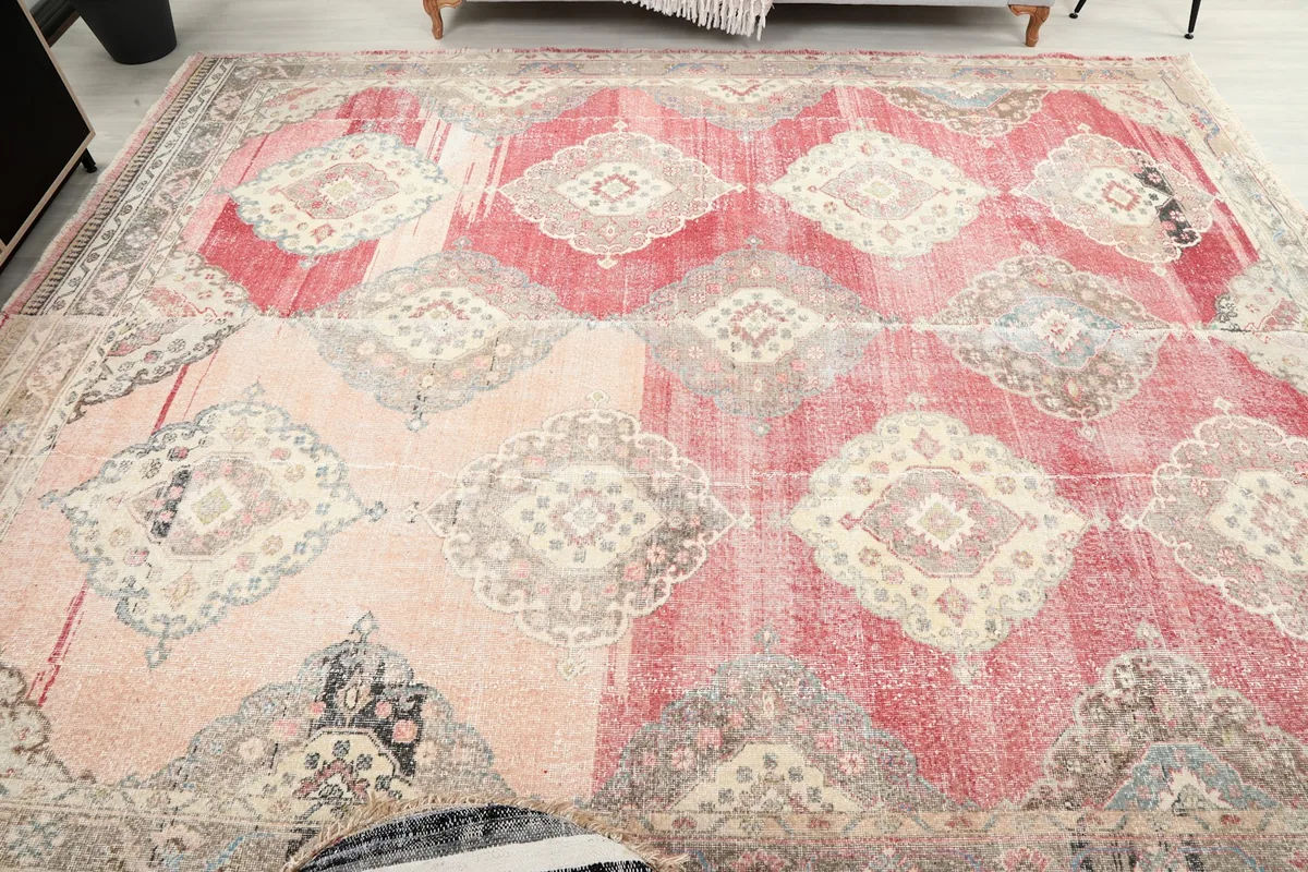 Wide overhead shot of the rug on the floor, capturing its distressed appearance