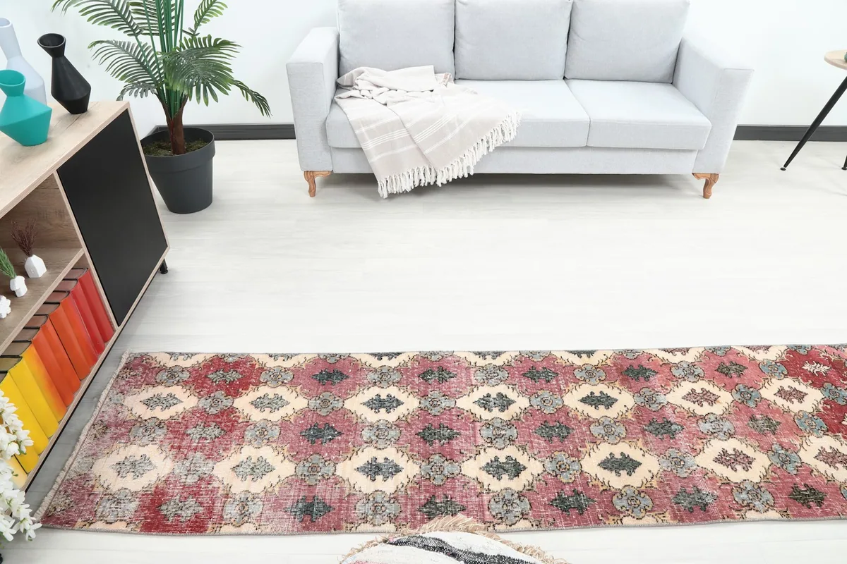 Overhead shot of the runner rug in a room setting, highlighting its colors and placement beneath a sofa.