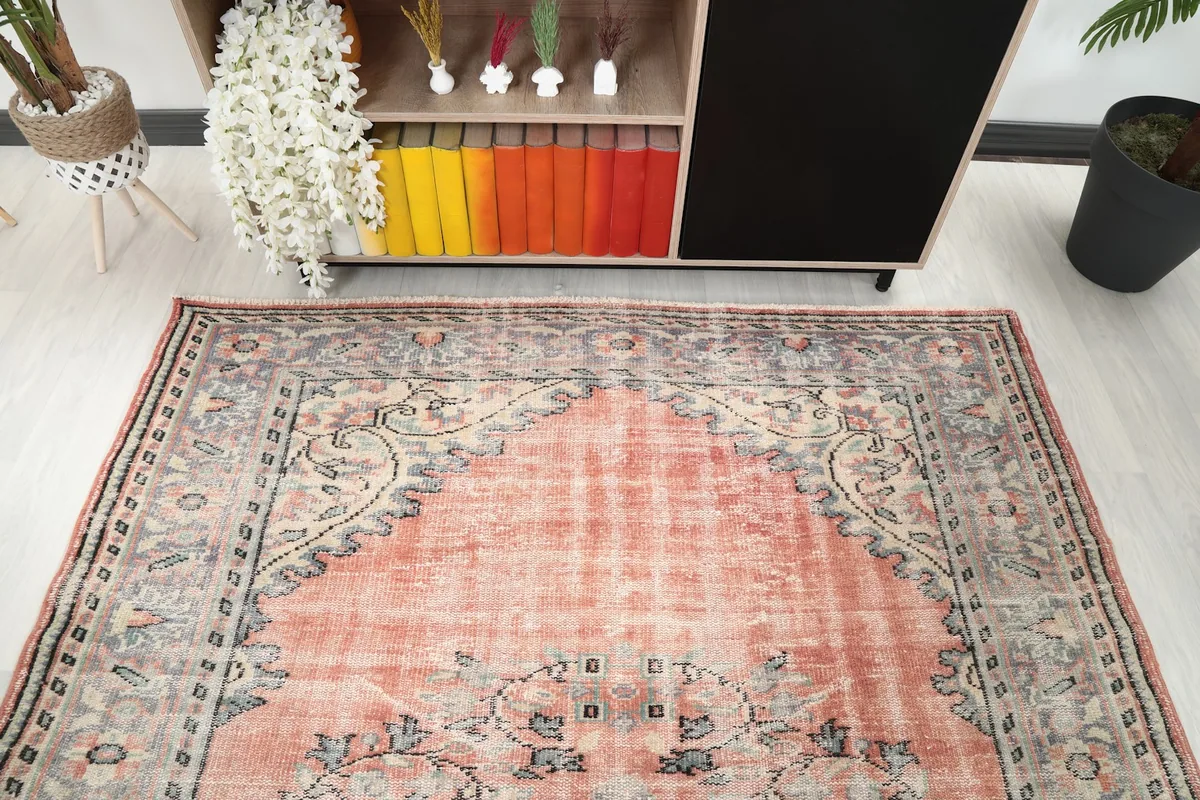View of the upper portion of the rug with its rose field and gray border