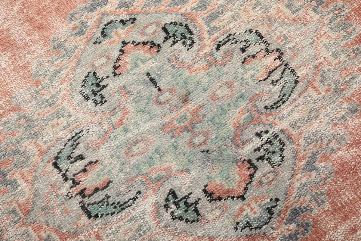 Detailed close-up of the distressed wool pile and intricate patterns