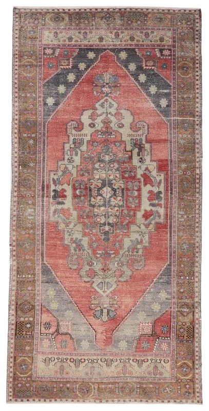 Full overhead view of the rust, brown, and gray vintage Anatolian area rug on a white background.
