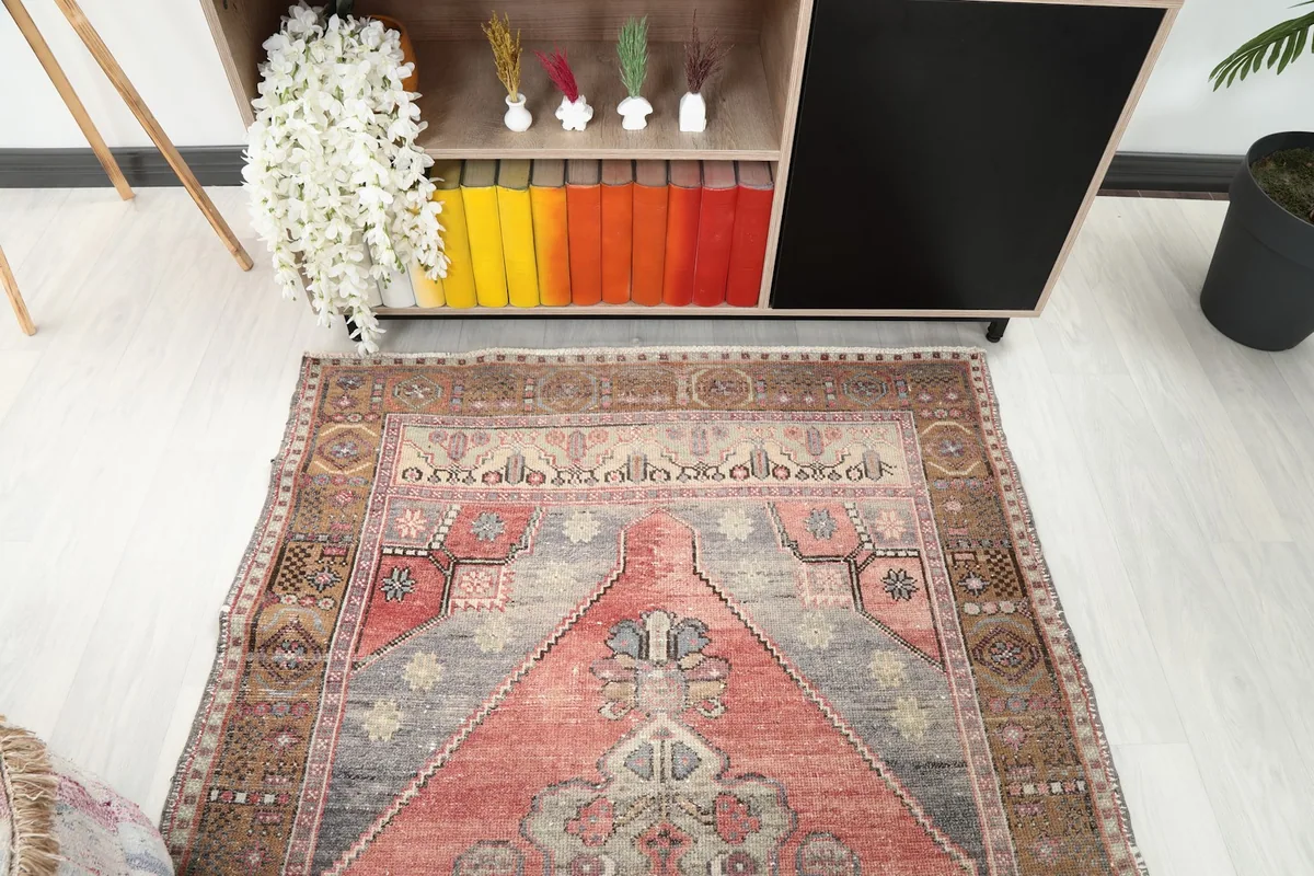 Angled view focusing on the upper portion of the rug, showing details of the rust and brown tones.