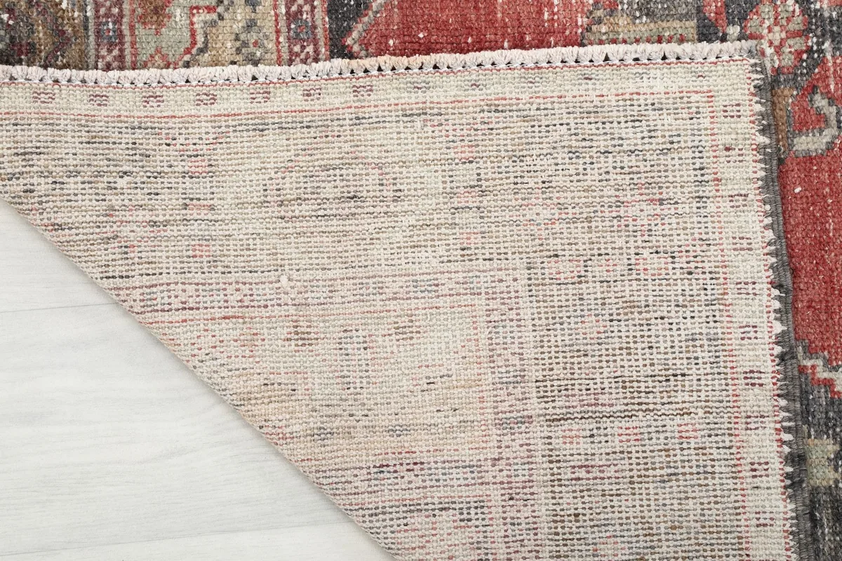 Close-up of the rug's underside, showing the tightly woven cotton foundation and knots.