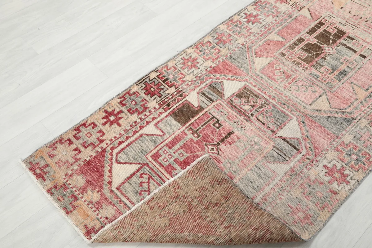Folded corner of the runner, revealing the hand-knotted wool pile and cotton foundation