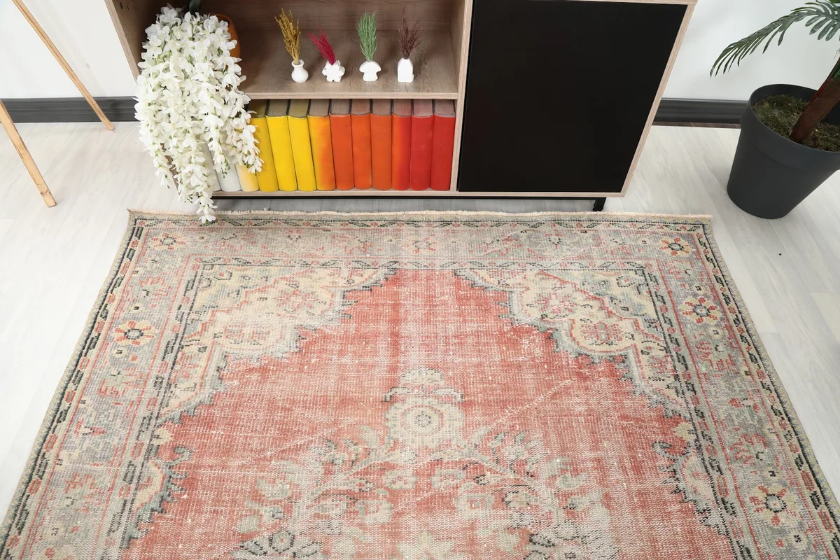 Detail of the rug's top portion in a room setting, focusing on the border and field design.