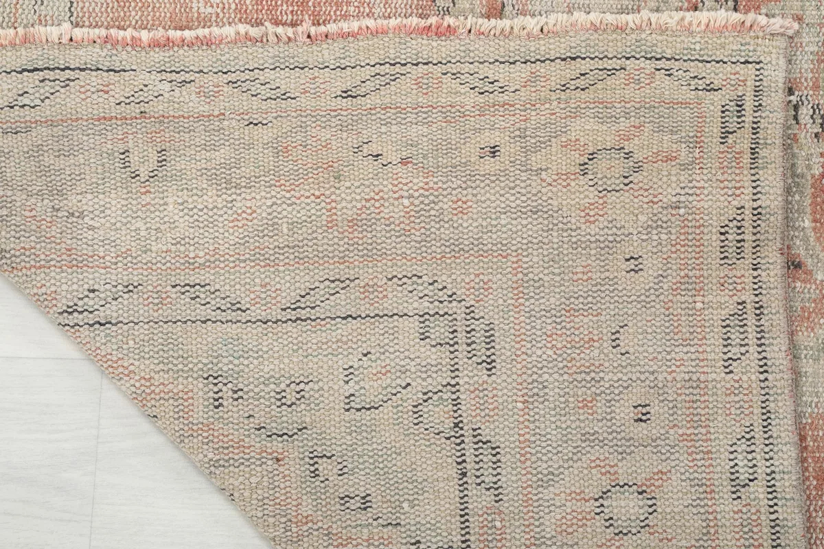 Detailed view of the rug's reverse side, illustrating the hand-knotted construction on a cotton foundation.