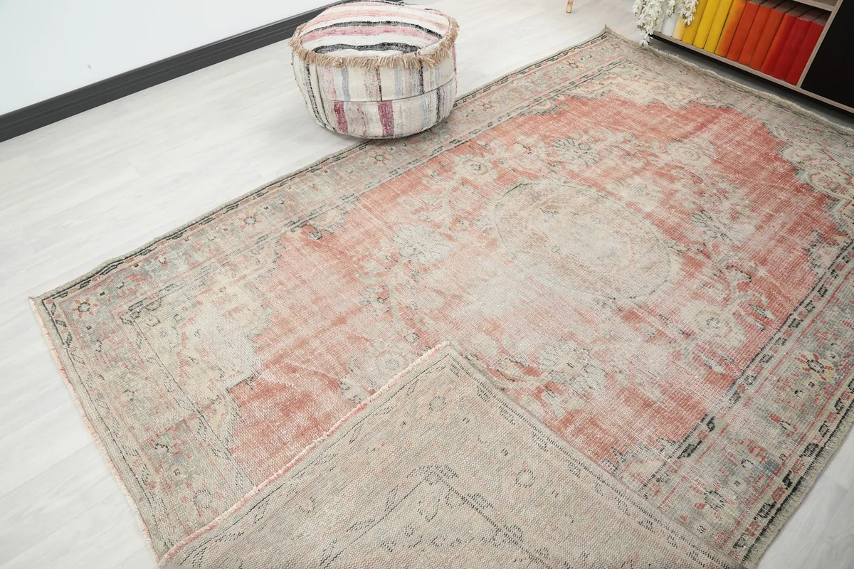 View of the rug with a corner folded back, showing the cotton foundation and the reverse side.