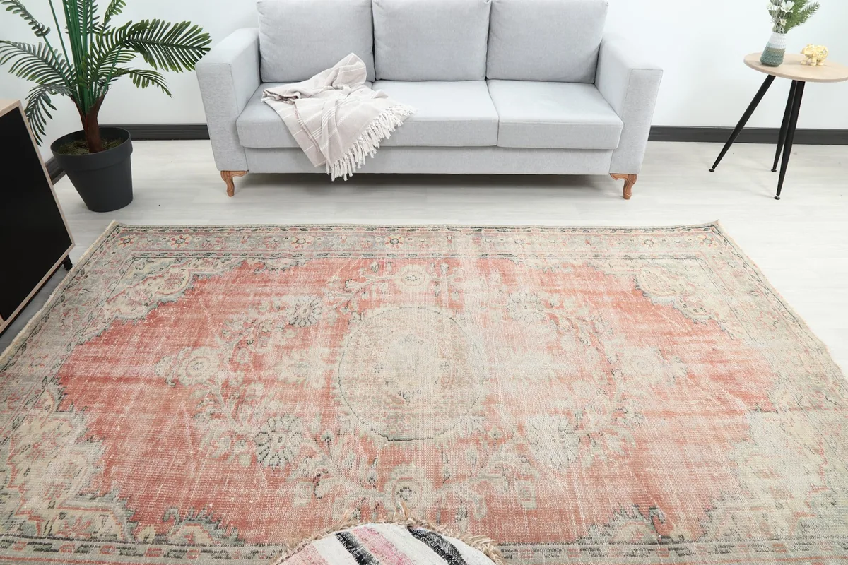 Overhead view of the rug in a living room, showcasing the central medallion and overall color palette.
