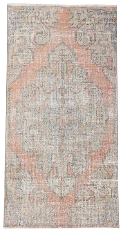 Top view of a rust and beige vintage Anatolian area rug with a central tribal medallion.