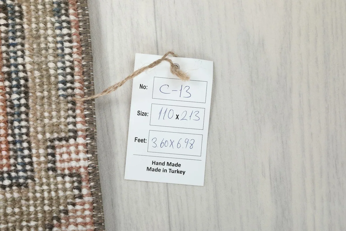 Product tag indicating the rug's size in centimeters and feet, and its origin from Turkey.