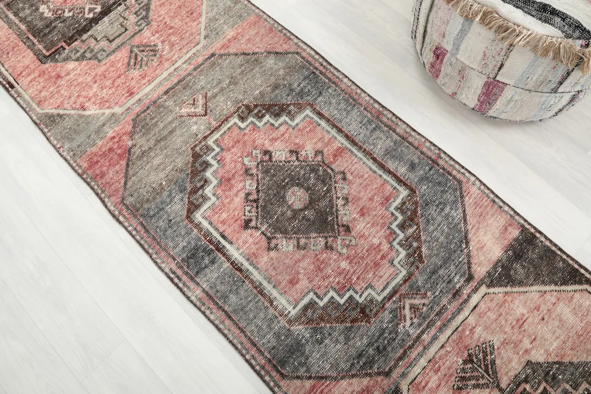 Angled view of the central geometric medallion with rose and gray tones
