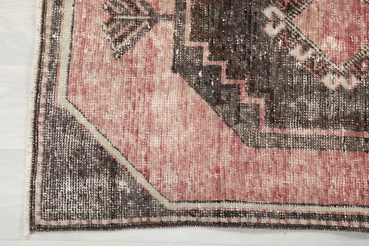 Close-up of the runner's border and corner, showing the edge finish and faded colors