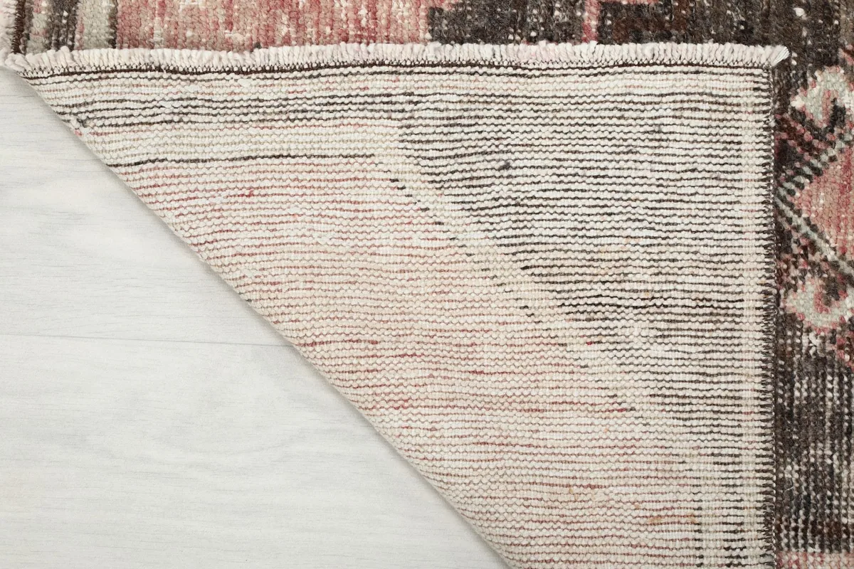 Detailed view of the rug's reverse side, showcasing the tight hand-knotting on a cotton base