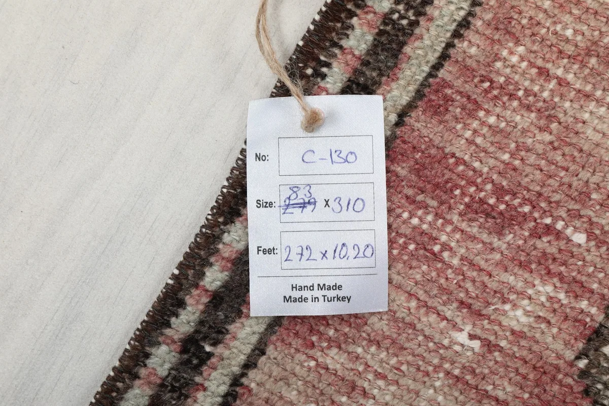 Product tag showing the rug's size in feet and centimeters and origin information
