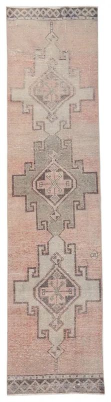Full overhead view of the vintage Anatolian runner rug with rose and gray geometric patterns on a white background.