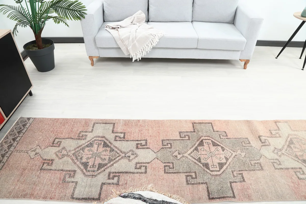 Overhead view of the runner rug in a room setting, showing its placement in front of a light gray sofa.