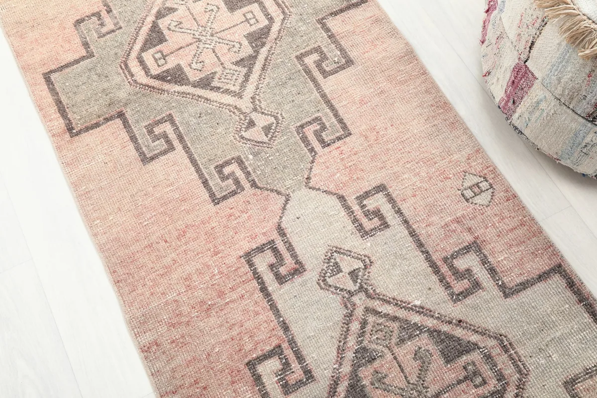 Close-up view of the central geometric patterns in gray and charcoal against the rose field.