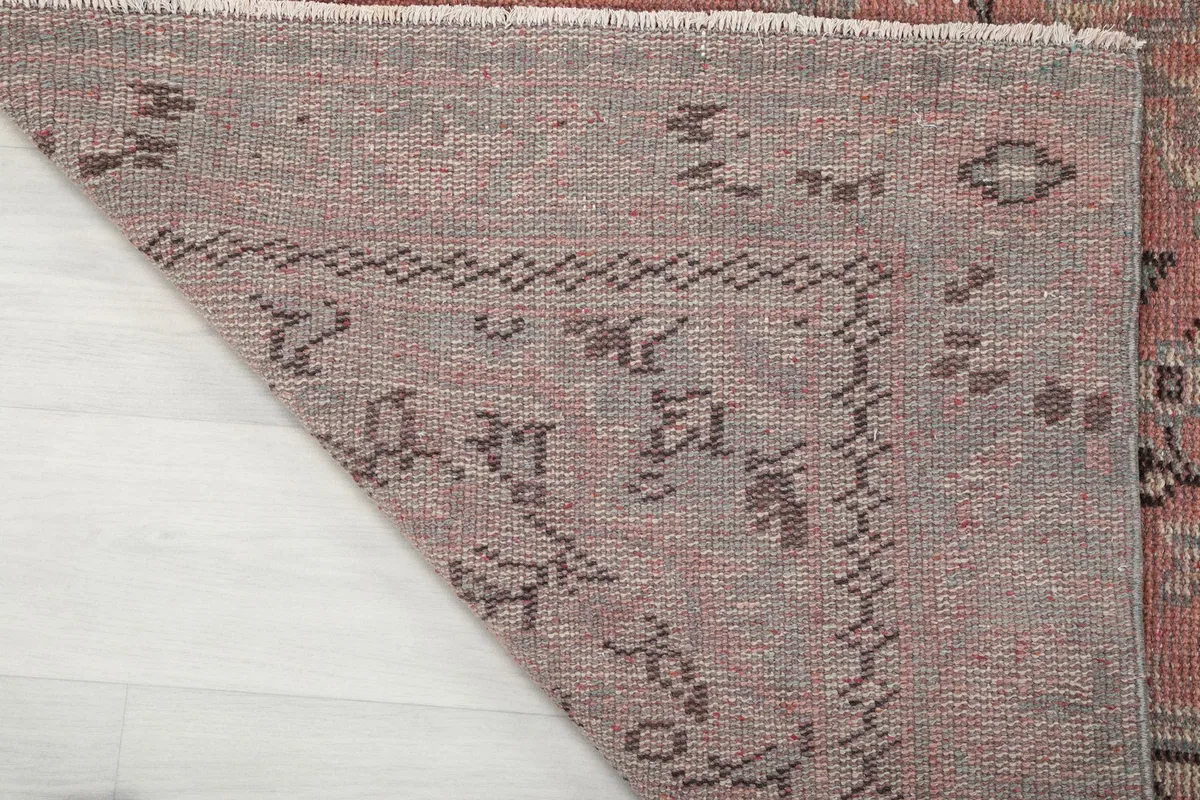 Close-up of the rug's reverse side, revealing the intricate knotting and cotton foundation