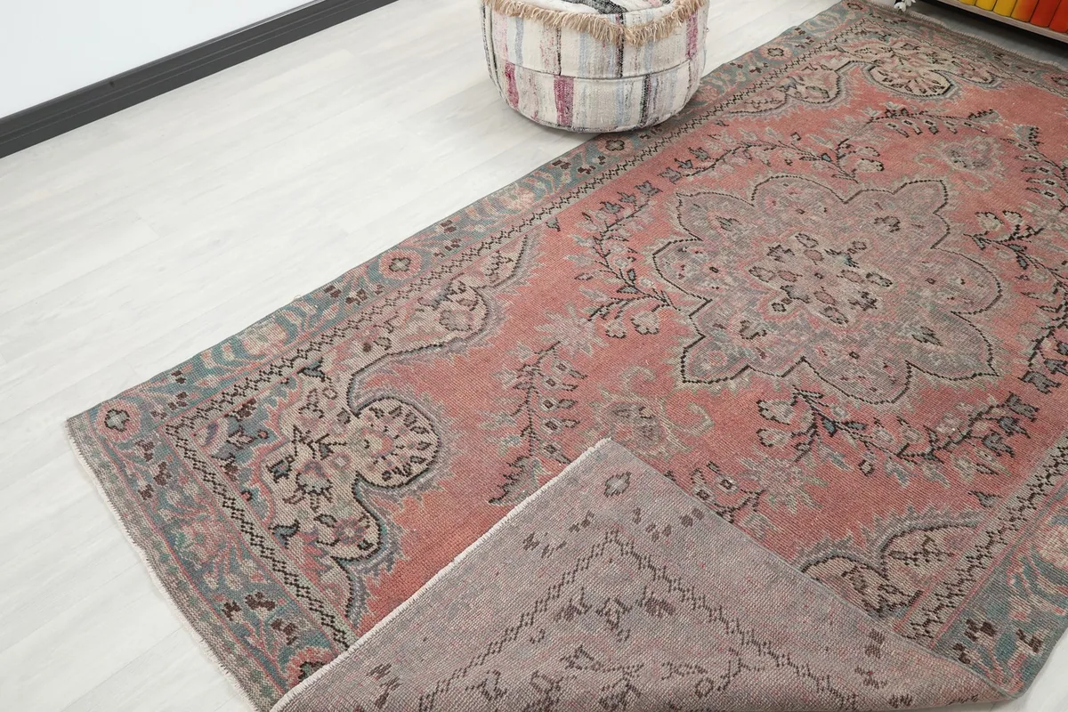 Rug corner folded back, showing the back of the hand-knotted wool on cotton foundation