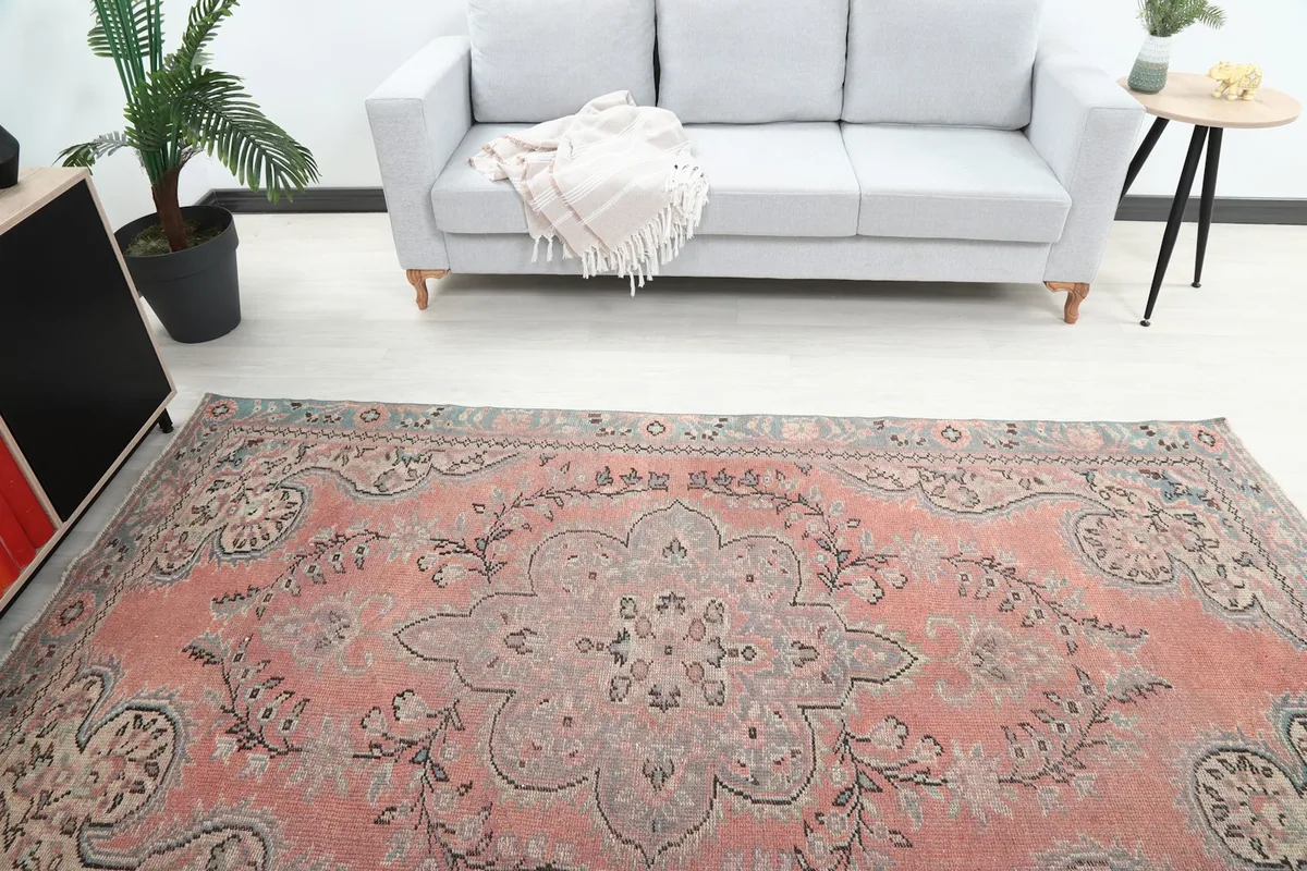 Overhead view focusing on the central medallion and floral patterns of the rose rug