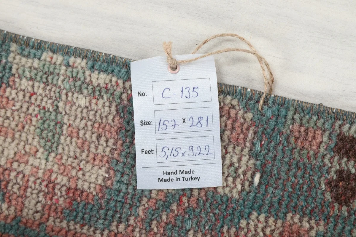 Product tag showing the rug's dimensions in centimeters and feet, and origin