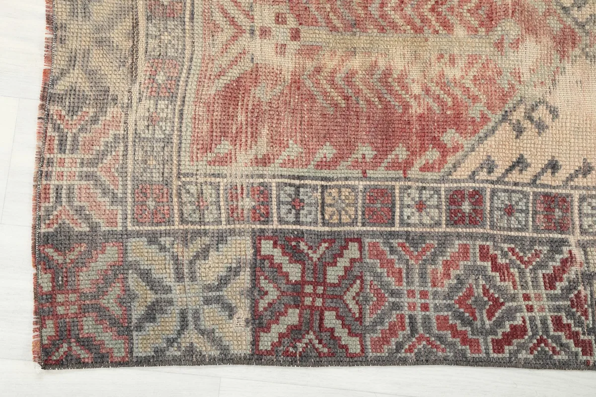 Detailed view of the rug's side border with its repeating geometric motifs