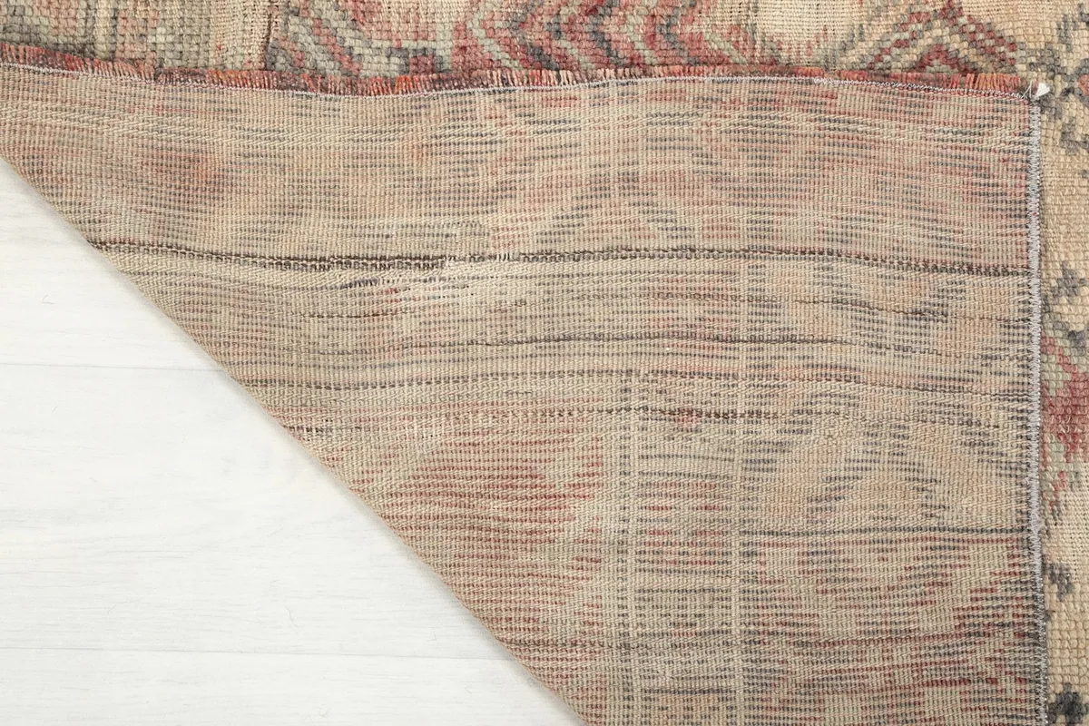View of the back of the rug, revealing the cotton foundation and hand-knotting