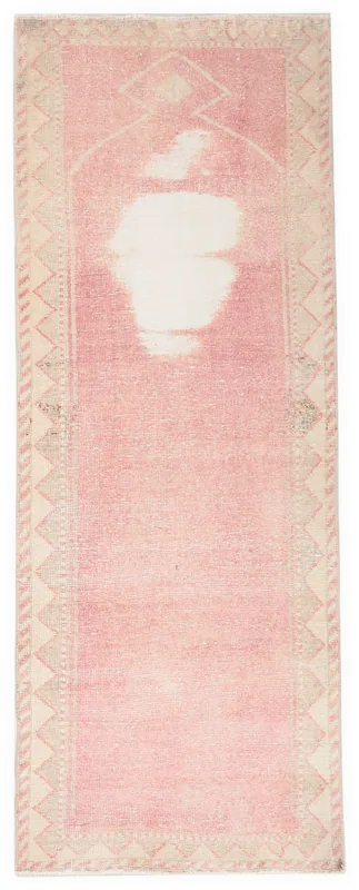 Full overhead view of the 2'10" x 7'5" vintage Anatolian runner rug with rose pink field and beige geometric border.
