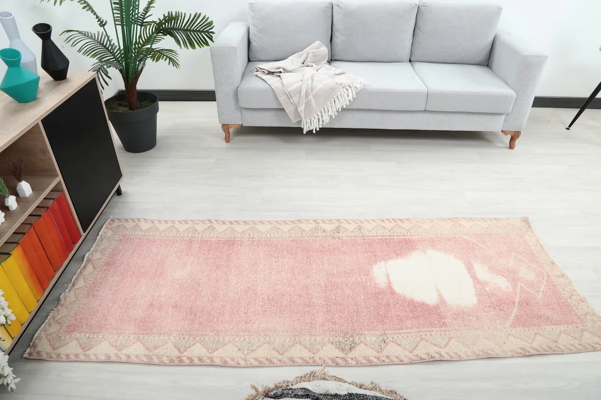Overhead view of the vintage runner rug in a room, capturing its full length from a higher perspective.