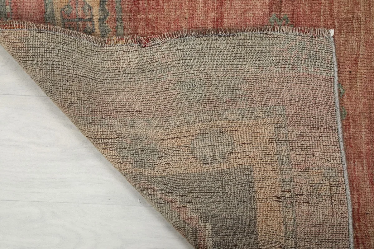 Close-up of the rug's hand-knotted cotton foundation on the reverse side