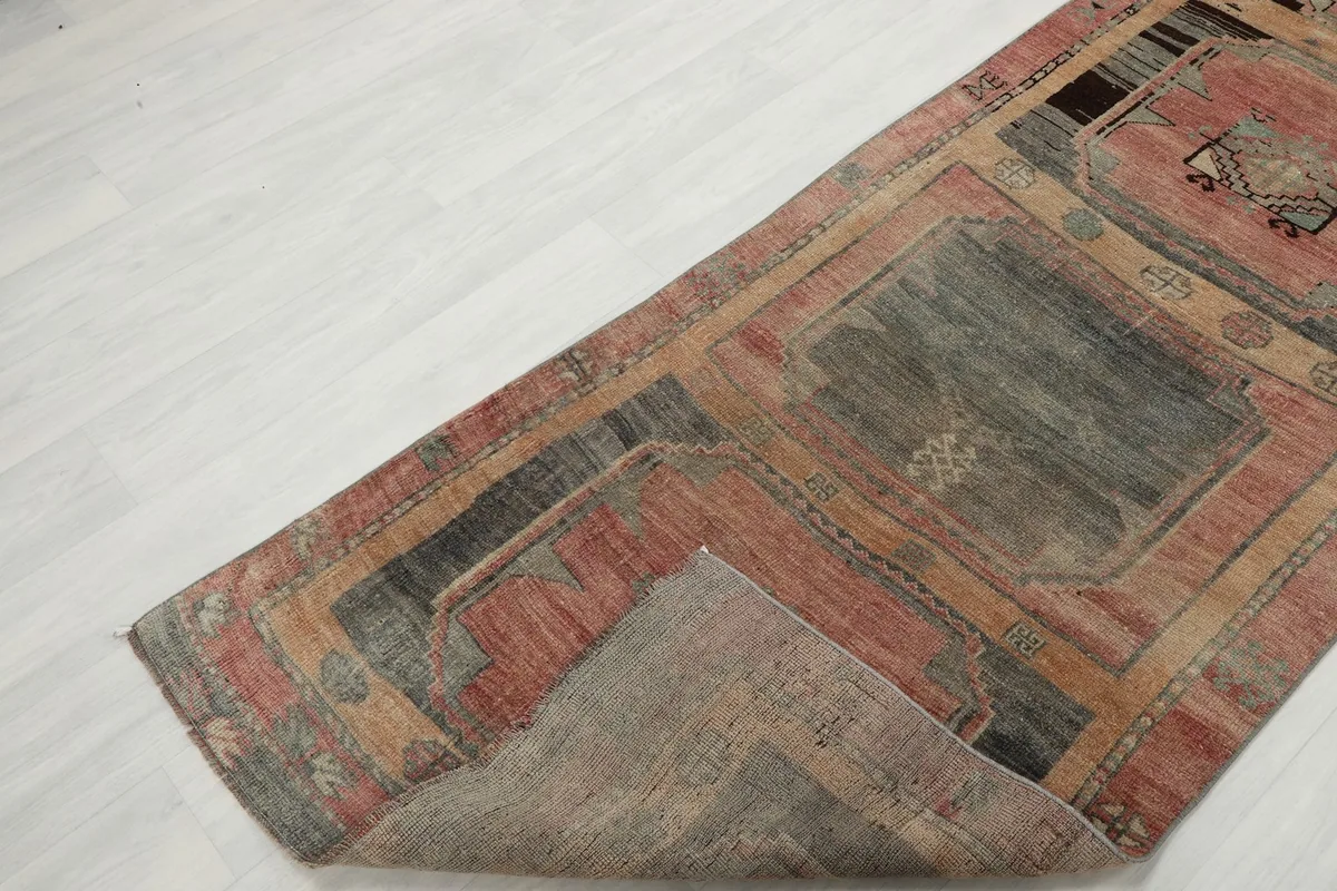 View of the runner rug folded to show the cotton foundation and the back of the weave