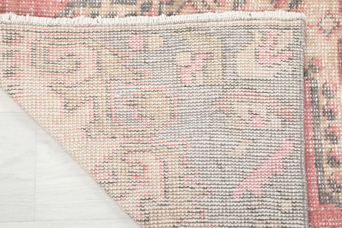 Underside view of the rug, showing the hand-knotted cotton foundation and tight weave.