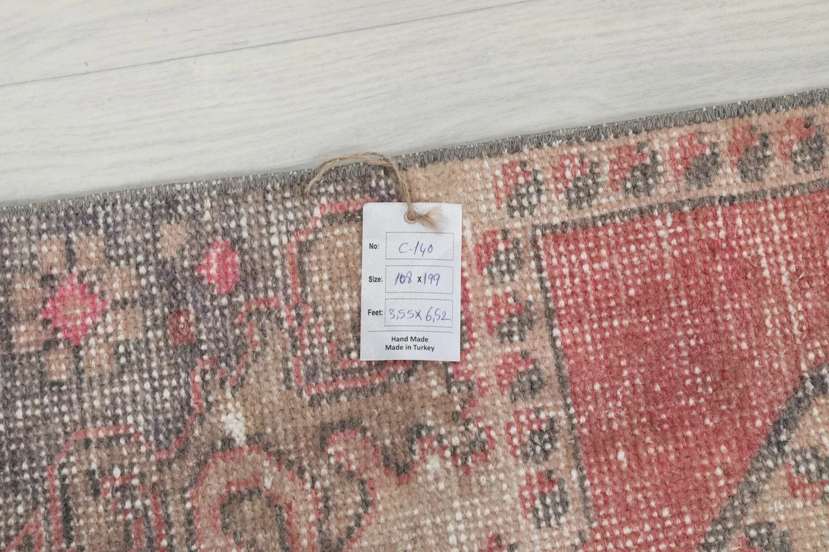 Close-up showing the product tag with rug dimensions and origin, placed on the rug's surface.