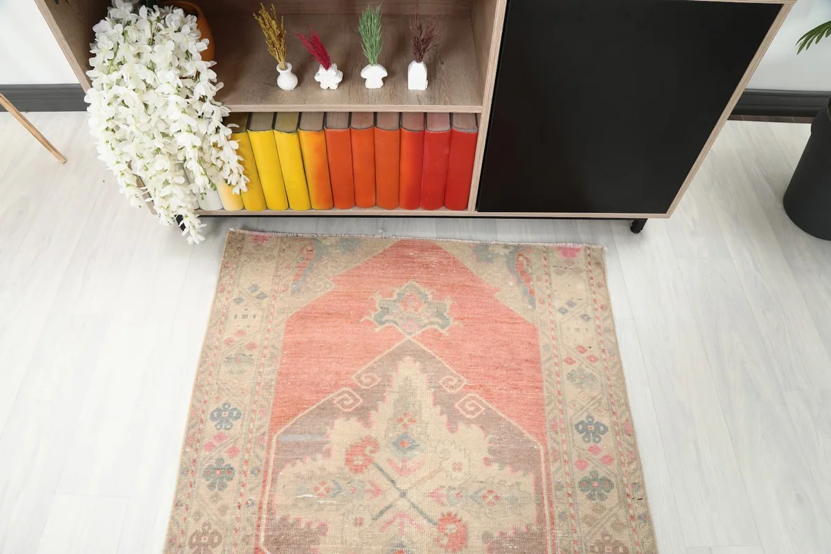 Detail view of the rug's pattern and colors from an elevated angle in a room