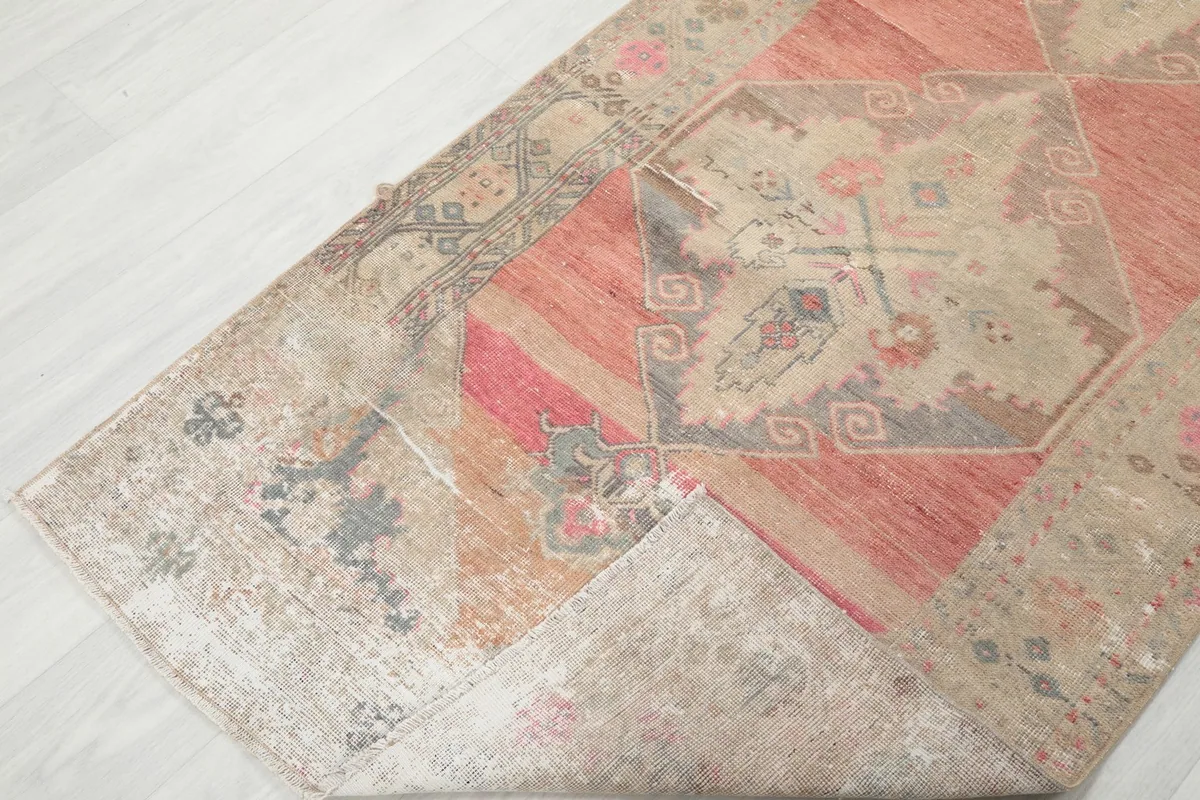 View of the rug folded over to show the back and front texture and color variations