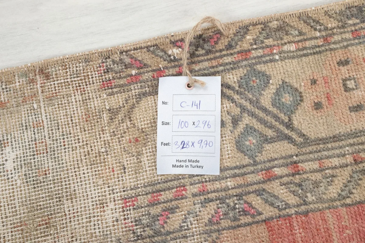 Close-up of the rug's border with a tag showing its size and origin details