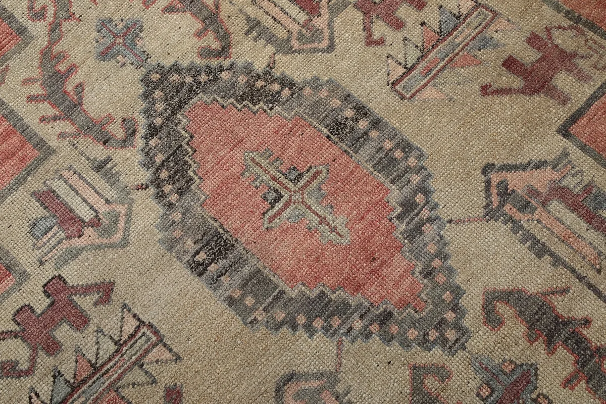 Detailed close-up of the central medallion and surrounding intricate tribal motifs on the rug