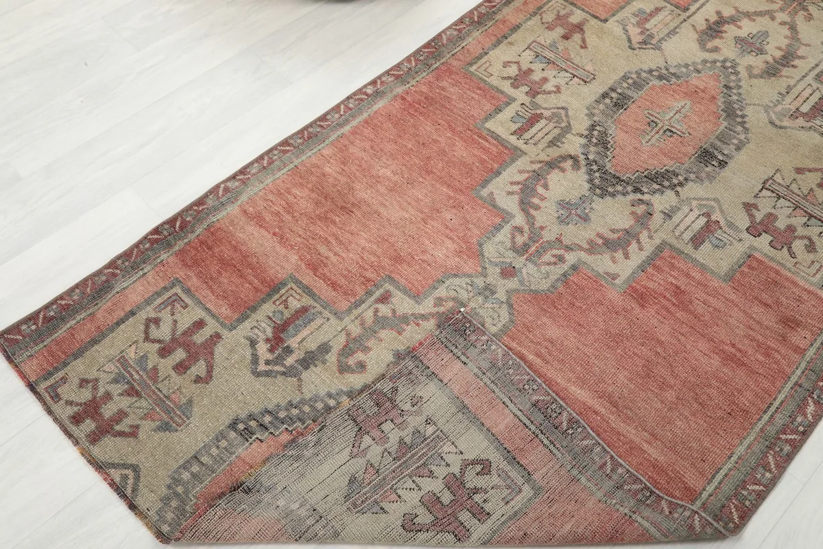View of the rug folded to show the back and thickness, highlighting its hand-knotted construction