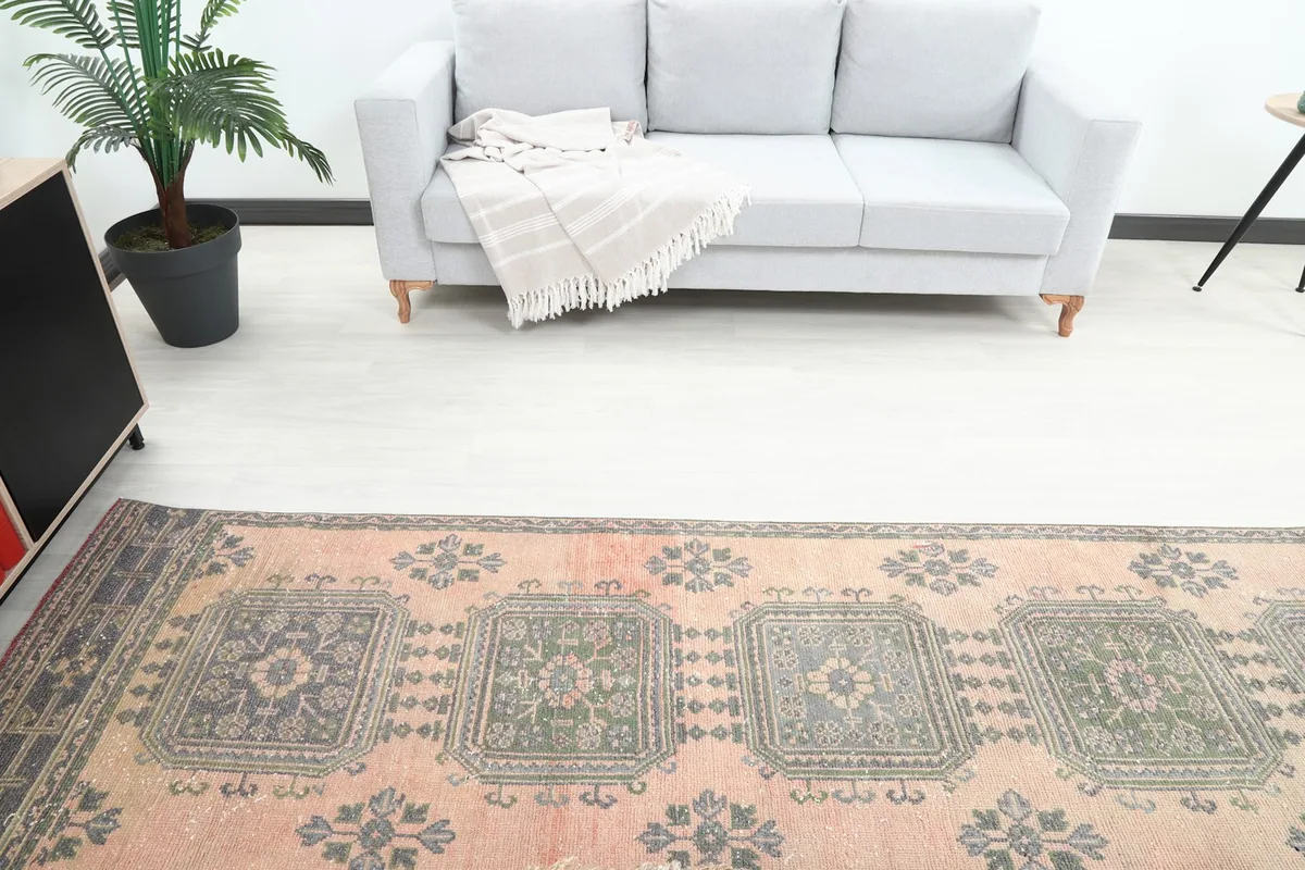 Runner rug in a room, viewed from above a light gray sofa, showcasing its design and scale.