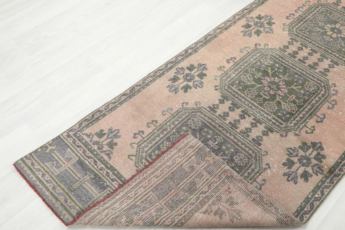 Runner rug folded to reveal the underside, showing the cotton foundation and knotting.