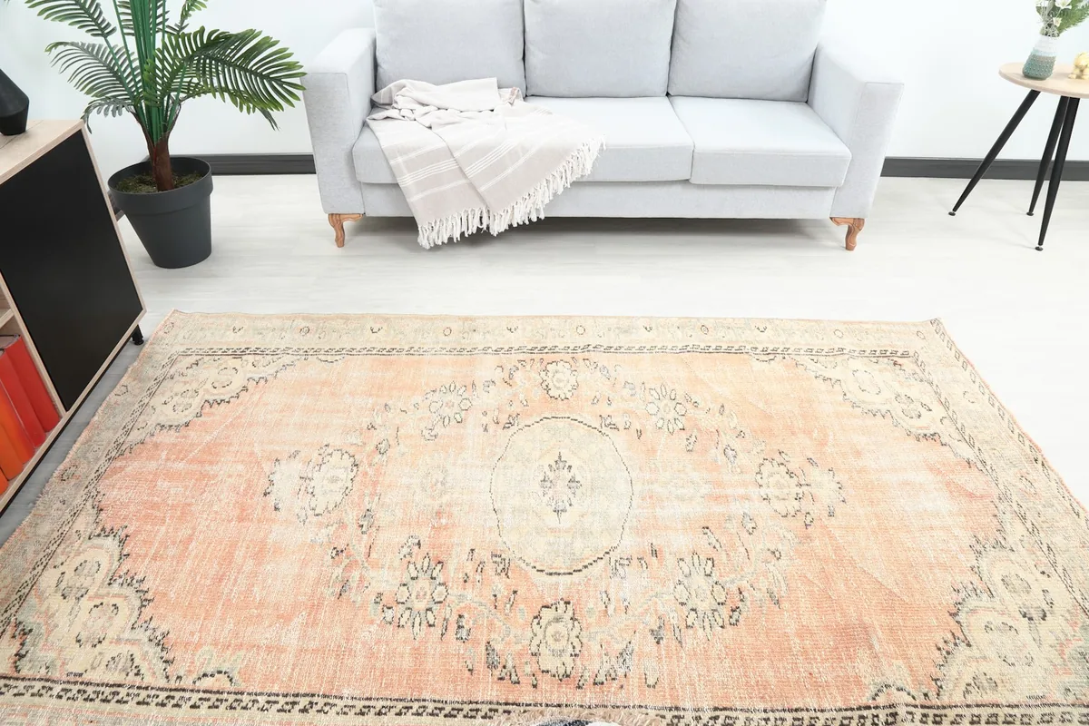 Overhead view of the orange rug in a room, showing the full design and surrounding furniture
