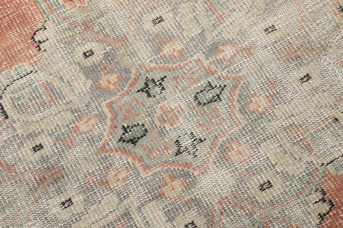 Close-up of the geometric patterns and distressed texture within the gray border area