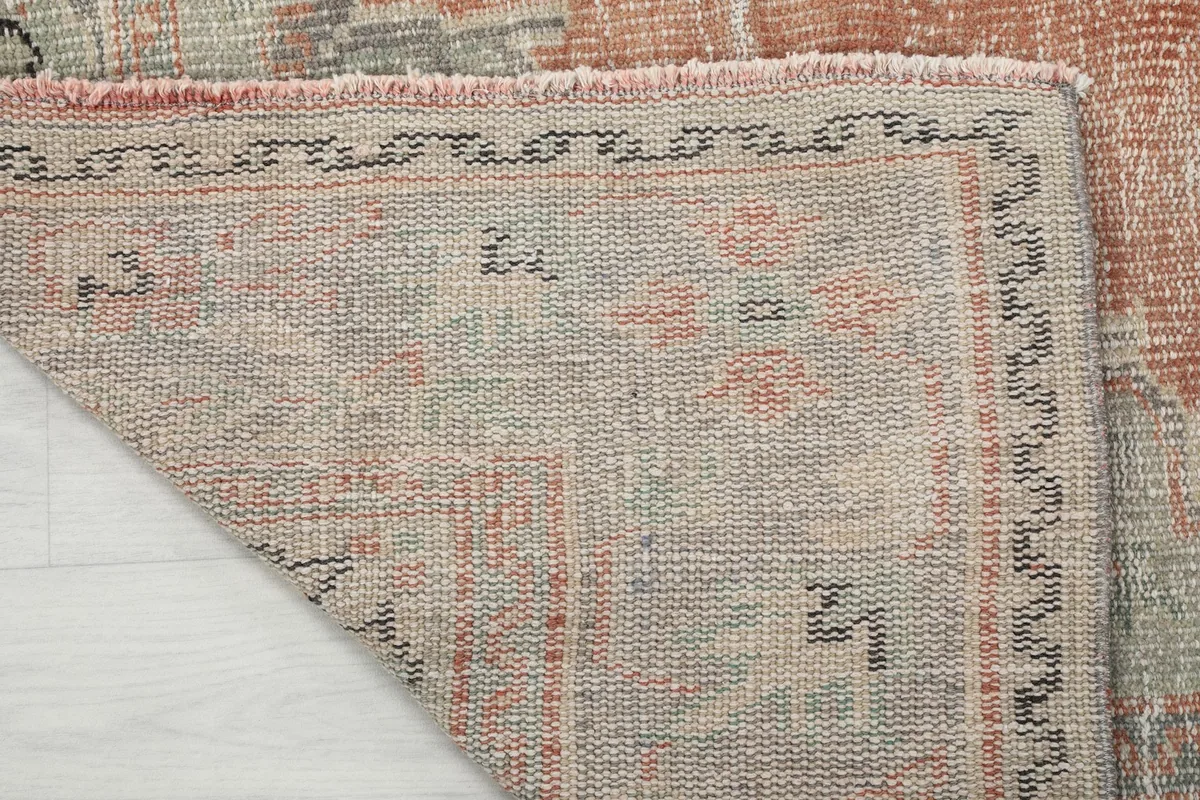 Close-up of the back of the rug, illustrating the hand-knotted construction and fringe