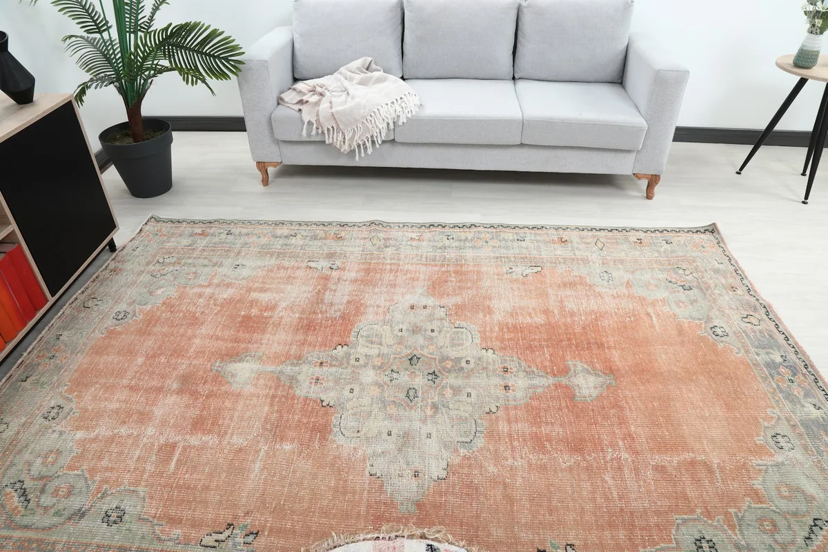 Overhead view of the vintage rug in a room, highlighting the central medallion and colors
