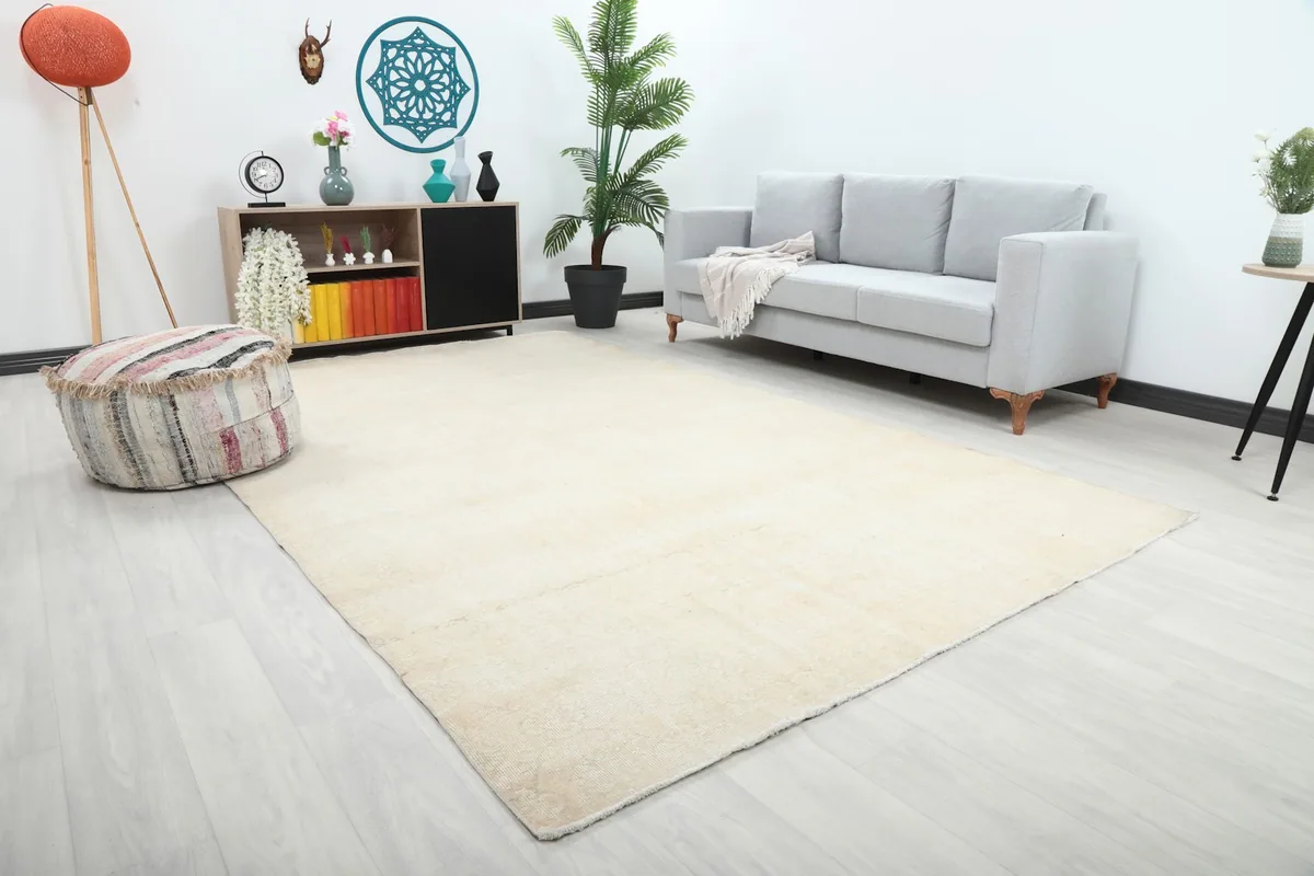 Angle view of the large ivory area rug in a modern living space with light-colored furniture