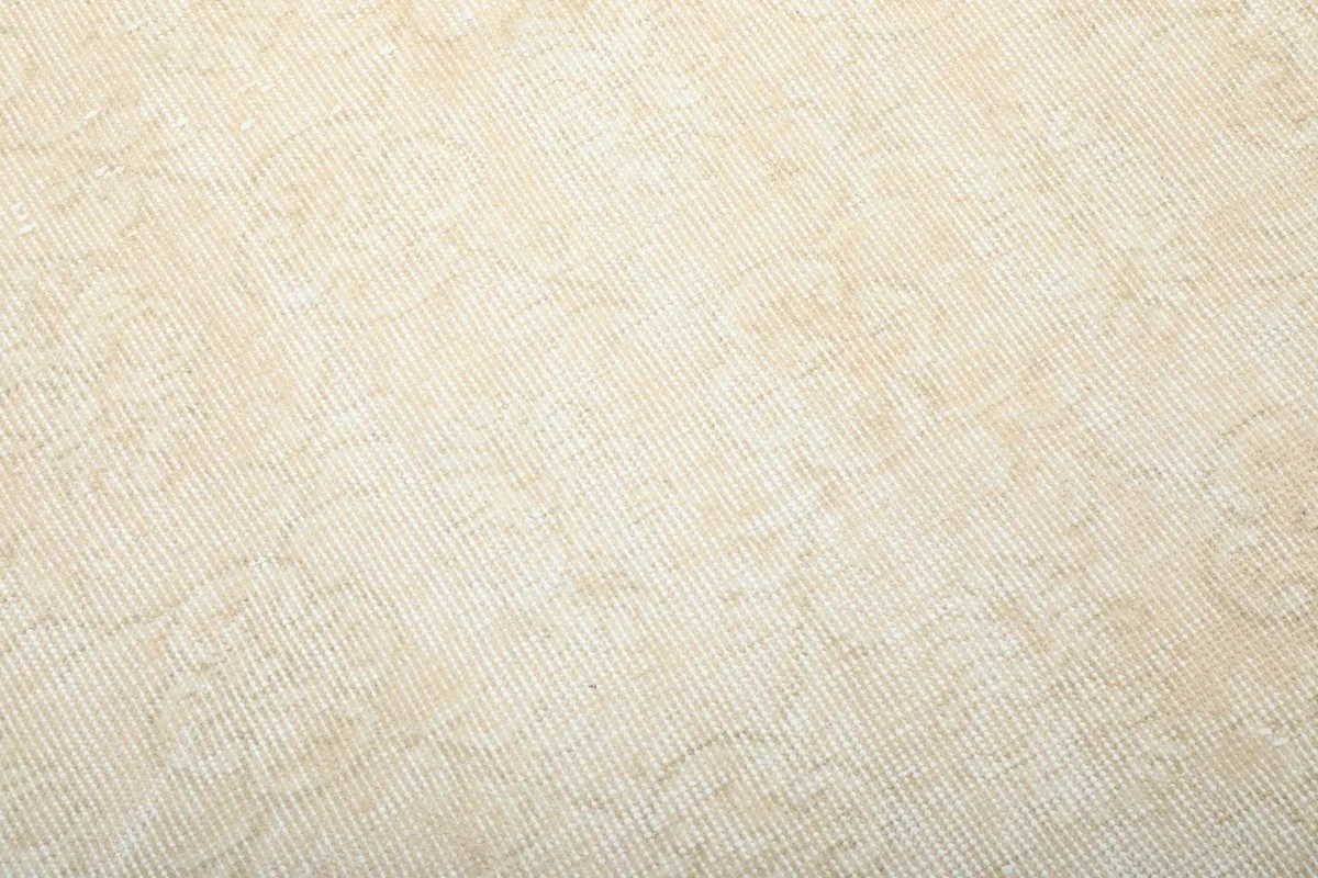 Detailed view of the hand-knotted wool pile texture and subtle color variations